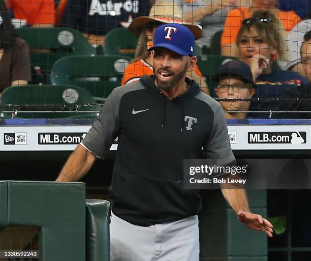 Chris Woodward of the Texas Rangers has words with home plate umpire Tim Timmons about the strikezone against the Houston Astros at Minute Maid Park...
