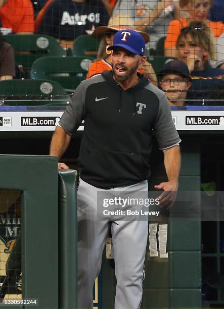 Chris Woodward of the Texas Rangers has words with home plate umpire Tim Timmons about the strikezone against the Houston Astros at Minute Maid Park...