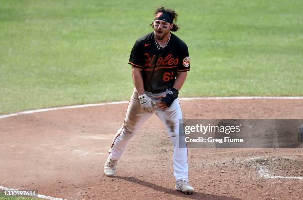 Ryan McKenna of the Baltimore Orioles celebrates after scoring the winning run in the ninth inning against the Washington Nationals at Oriole Park at...