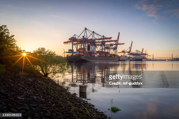big vessels in the evening at the gate. - finanzwirtschaft und industrie stock pictures, royalty-free photos & images