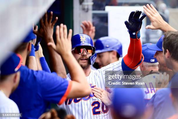 Pete Alonso of the New York Mets is congratulated by his teammates after hitting a two run home run against the Toronto Blue Jays during the sixth...