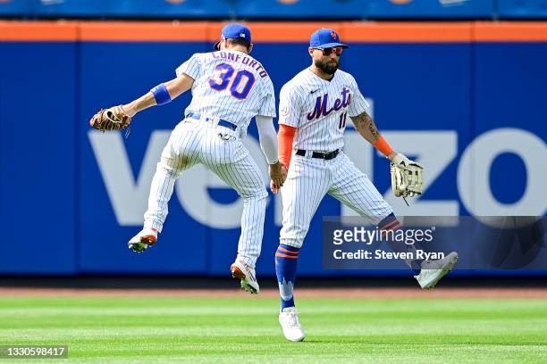 Michael Conforto and Kevin Pillar of the New York Mets celebrate the team's 5-4 win against the Toronto Blue Jays at Citi Field on July 25, 2021 in...