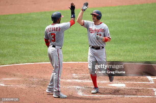 Ryan Zimmerman of the Washington Nationals celebrates with Alcides Escobar after hitting a three-run home run in the sixth inning against the...