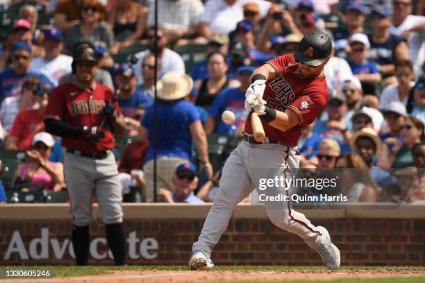 Kole Calhoun of the Arizona Diamondbacks hits a single in the seventh inning against the Chicago Cubs at Wrigley Field on July 25, 2021 in Chicago,...