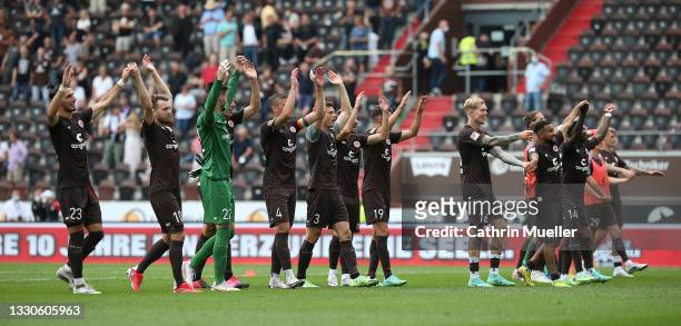 The Players of FC St. Pauli celebrate after winning the Second Bundesliga match between FC St. Pauli and Holstein Kiel at Millerntor Stadium on July...