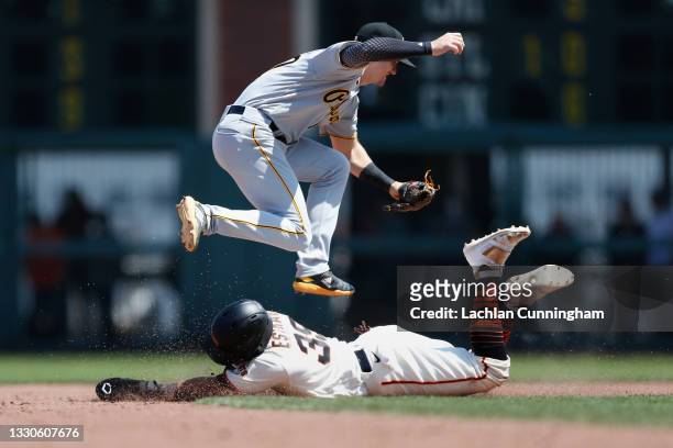 Thairo Estrada of the San Francisco Giants steals second base as Kevin Newman of the Pittsburgh Pirates is unable to catch throw from the catcher,...