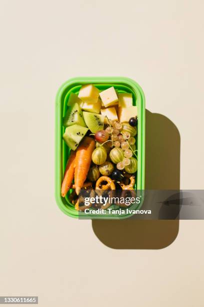 open lunch box with healthy lunch delicious food, fruits, berries, vegetables, snacks on beige background. concept of school nutrition. flat lay, top view - sack lunch stock pictures, royalty-free photos & images