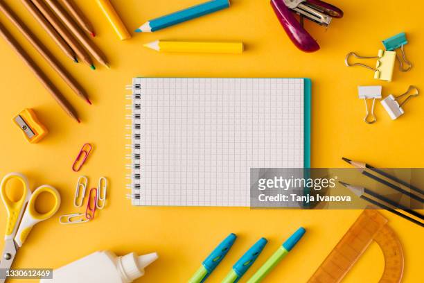 back to school concept. creative composition of school stationery white sheet of notebook paper on a yellow background. top view, flat lay, copy space. - notepad table stock pictures, royalty-free photos & images