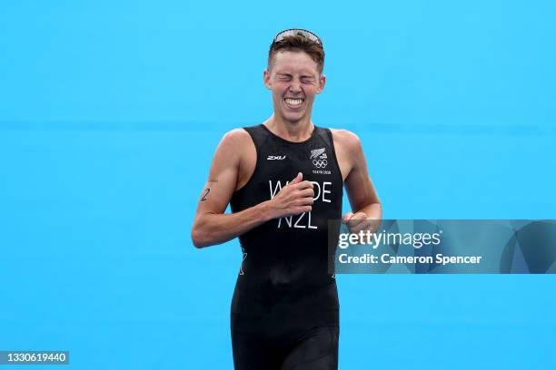 Bronze medalist Hayden Wilde of Team New Zealand reacts as he crosses the finish line during the Men's Individual Triathlon on day three of the Tokyo...