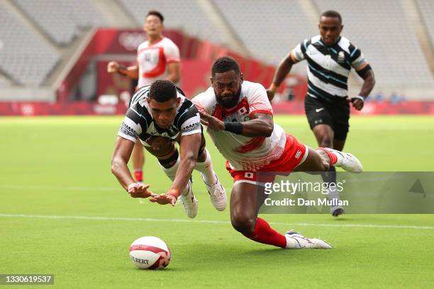 Meli Derenalagi of Team Fiji and Lote Tuqiri of Team Japan compete for the ball on day three of the Tokyo 2020 Olympic Games at Tokyo Stadium on July...