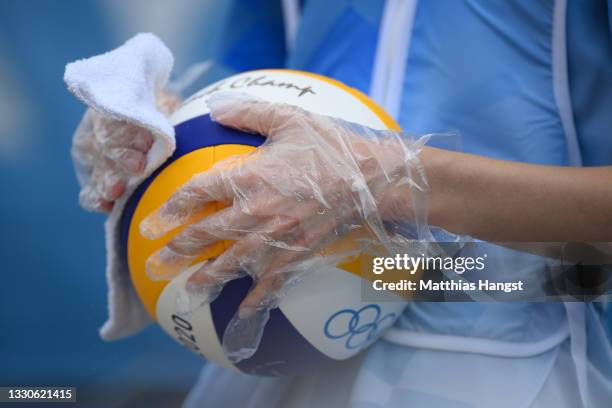 Volleyball gets disinfected during the Women's Preliminary - Pool D beach volleyball match between Team United States and Team Latvia on day three of...