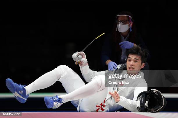 Sui Lun Cheung of Team Hong Kong is looked at after a hard hit to his chest by Andre Sanita of Team Germany in Men's Foil Individual first round on...