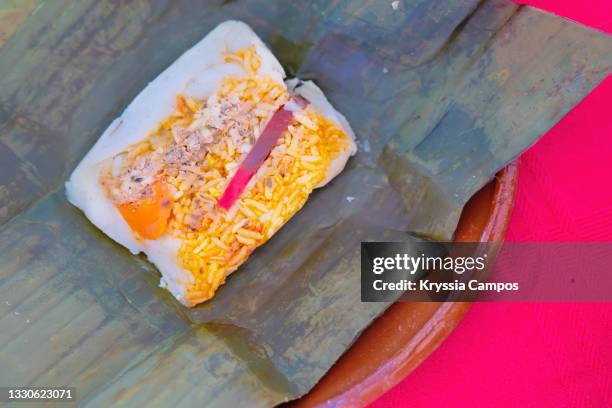 corn and pork meat tamale ready to eat (unwrapped from it's banana leaves, typical costa rican food) - tamal de maíz fotografías e imágenes de stock