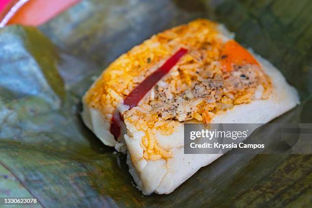 corn and pork meat tamale ready to eat (unwrapped from it's banana leaves, typical costa rican food) - tamal de maíz fotografías e imágenes de stock