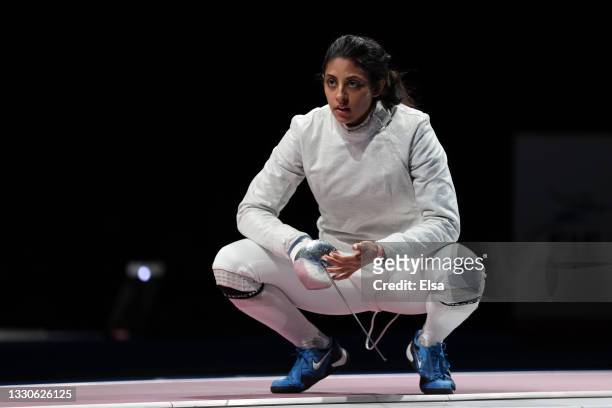 Nada Hafez of Team Egypt awaits medical attention during her bout against Jiyeon Kim of Team South Korea in Women's Sabre Individual first round on...