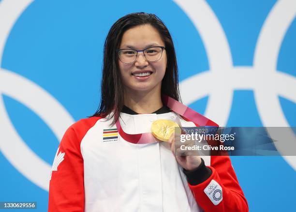 Margaret Macneil of Team Canada poses with the gold medal for the Women's 100m Butterfly Final on day three of the Tokyo 2020 Olympic Games at Tokyo...