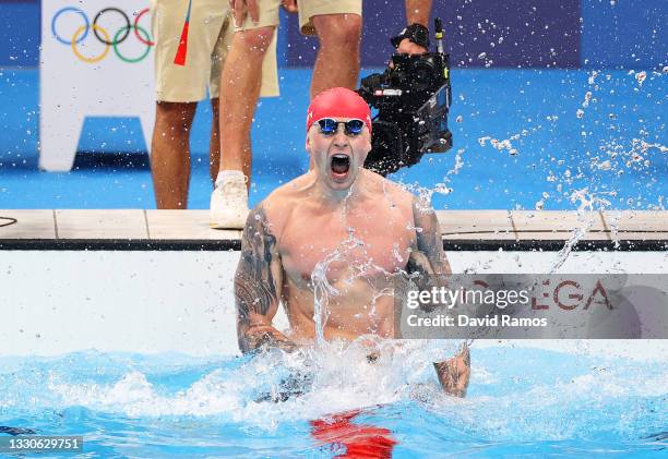 Adam Peaty of Team Great Britain celebrates after winning the gold medal in the Men's 100m Breaststroke Final on day three of the Tokyo 2020 Olympic...