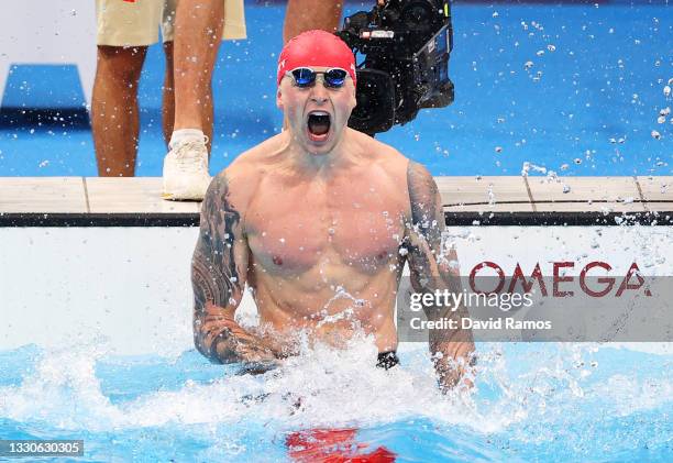 Adam Peaty of Team Great Britain celebrates after winning the gold medal in the Men's 100m Breaststroke Final on day three of the Tokyo 2020 Olympic...