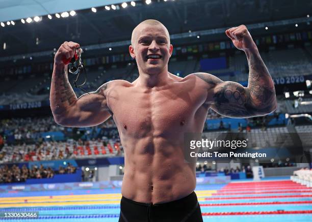 Adam Peaty of Team Great Britain reacts after winning the gold medal in the Men's 100m Breaststroke Final on day three of the Tokyo 2020 Olympic...