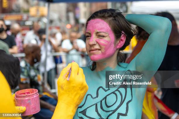 Niki Davis reacts to having her face painted during the 8th annual ‘NYC Body Painting Day’ organized by Human Connection Arts in Union Square on July...