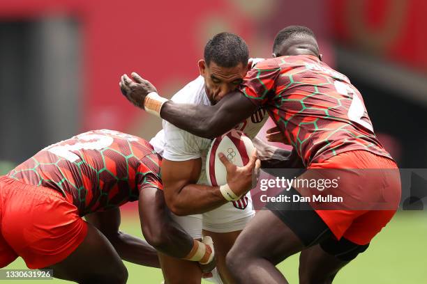 Martin Iosefo of Team United States is tackled by Willy Ambaka and Herman Humwa of Team Kenya on day three of the Tokyo 2020 Olympic Games at Tokyo...
