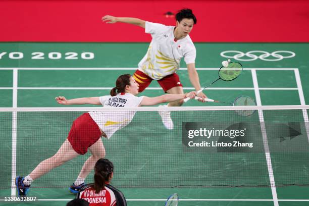 Yuta Watanabe and Arisa Higashino of Team Japan compete against Praveen Jordan and Melati Daeva Oktavianti of Team Indonesia during a Mixed Doubles...