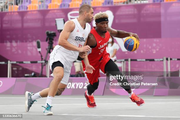 Ira Brown of Team Japan drives past Dusan Domovic Bulut of Team Serbia on day three of the Tokyo 2020 Olympic Games at Aomi Urban Sports Park on July...