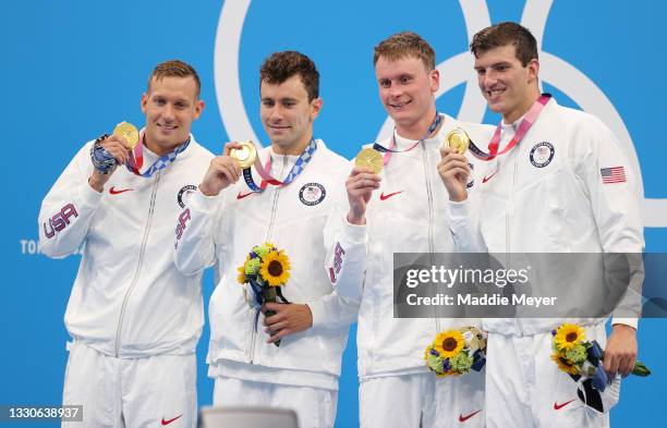 Caeleb Dressel, Blake Pieroni, Bowen Becker and Zach Apple of Team United States pose with their gold medals for the Men's 4 x 100m Freestyle Relay...