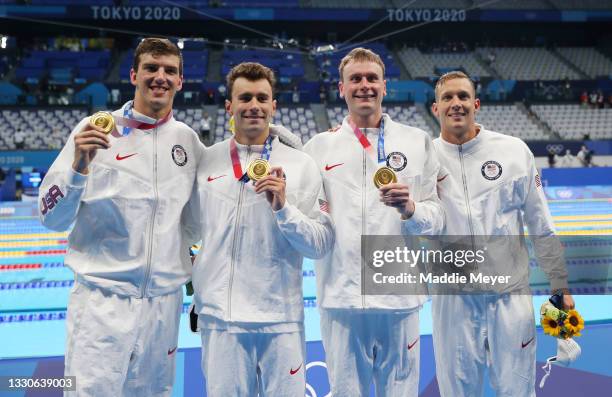 Zach Apple, Blake Pieroni, Bowen Becker and Caeleb Dressel of Team United States pose with their gold medals for the Men's 4 x 100m Freestyle Relay...