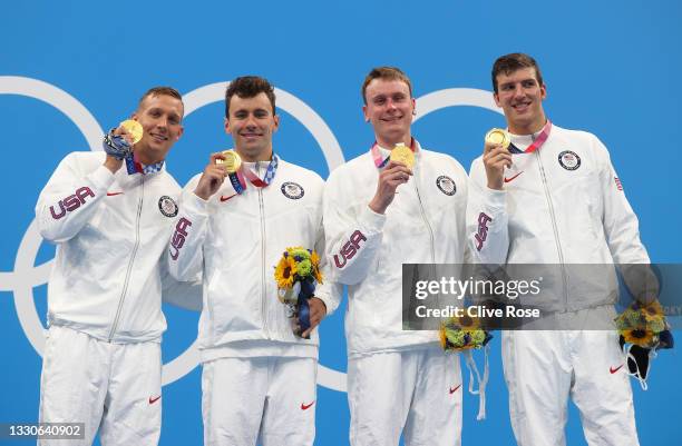 Caeleb Dressel, Blake Pieroni, Bowen Becker and Zach Apple of Team United States pose with their gold medals for the Men's 4 x 100m Freestyle Relay...