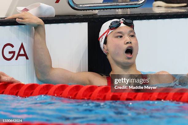 Margaret Macneil of Team Canada celebrates after winning the gold medal in the Women's 100m Butterfly Final on day three of the Tokyo 2020 Olympic...