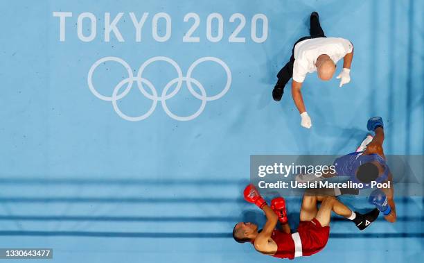 Eldric Sella Rodriguez of Refugee Olympic Team is knocked down by Euri Cedeno Martinez of Dominican Republic during the Men's Middle on day three of...