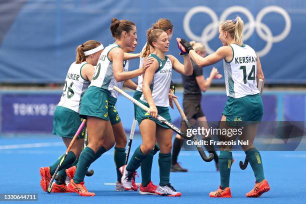 Emily Chalker of Team Australia is congratulated by her teammates after scoring a goal against Team China during the Women's Preliminary Pool B match...