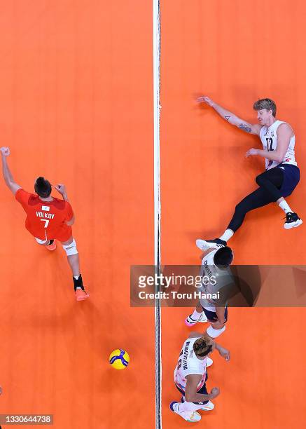 Maxwell Holt of Team United States and Dmitry Volkov of Team ROC battle at the net during the Men's Preliminary Round - Pool B volleyball on day...