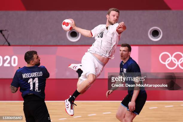 Philipp Weber of Team Germany shoots at goal while Lucas Dario Moscariello and Ramiro Martinez of Team Argentina look on during the Men's Preliminary...