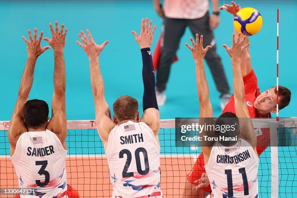 Dmitry Volkov of Team ROC attacks at the net against Team United States during the Men's Preliminary Round - Pool B volleyball on day three of the...