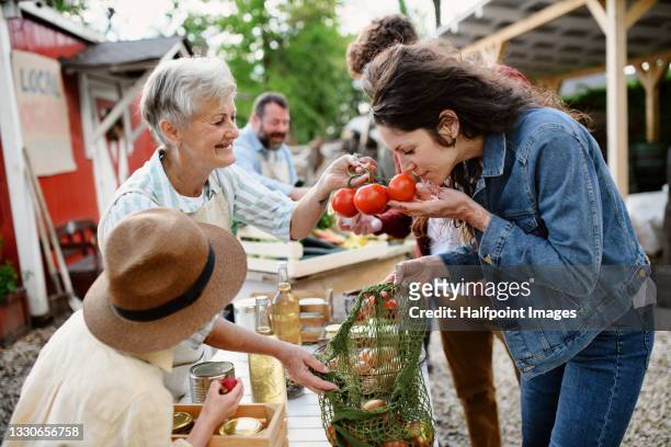 woman buying organic vegetables on farmers market. - slovakia food stock pictures, royalty-free photos & images