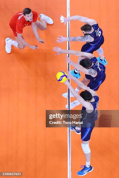 Team Italy blocks the hit by Team Poland during the Men's Preliminary Round - Pool A volleyball on day three of the Tokyo 2020 Olympic Games at...