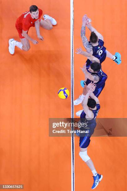 Team Italy blocks the hit by Team Poland during the Men's Preliminary Round - Pool A volleyball on day three of the Tokyo 2020 Olympic Games at...