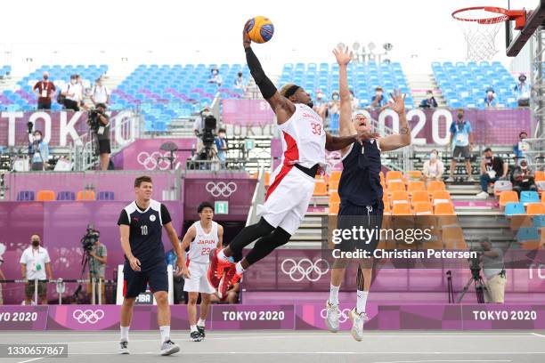 Ira Brown of Team Japan dunks against Stanislav Sharov of Team ROC in the 3x3 Basketball competition on day three of the Tokyo 2020 Olympic Games at...