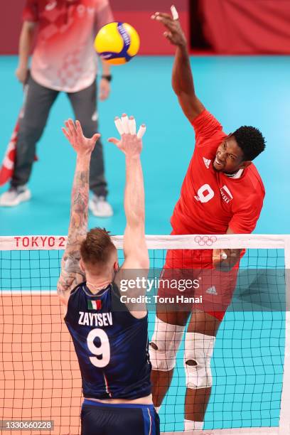 Wilfredo Leon Venero of Team Poland hits against Team Italy during the Men's Preliminary Round - Pool A volleyball on day three of the Tokyo 2020...