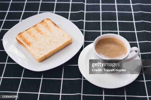 morning breakfast table with fresh wholemeal homemade rural bread on a wooden background. wheat bread with coffee cup on wooden table - grano cafe fotografías e imágenes de stock