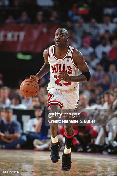 Michael Jordan of the Chicago Bulls dribbles against the Portland Trailblazers during the 1992 NBA Finals circa 1992 at Chicago Stadium in Chicago,...