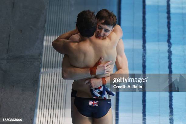 Tom Daley and Matty Lee of Team Great Britain celebrate during the Men's Synchronised 10m Platform Final on day three of the Tokyo 2020 Olympic Games...