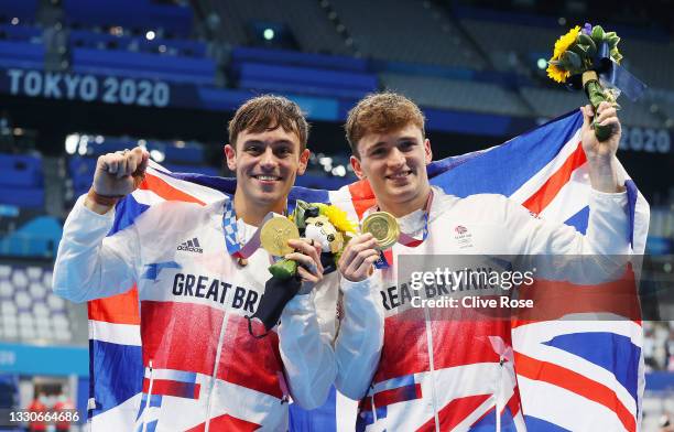 Thomas Daley and Matty Lee of Team Great Britain pose for photographers with their gold medals after winning the Men's Synchronised 10m Platform...