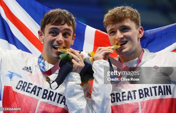 Thomas Daley and Matty Lee of Team Great Britain pose for photographers with their gold medals after winning the Men's Synchronised 10m Platform...