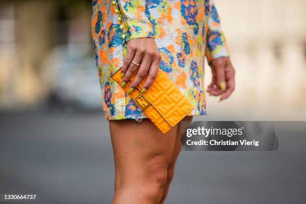 Tina Haase is seen wearing Rotate Birger Christensen dress with print, silver Scarosso heels, Fendi micro bag in orange on July 25, 2021 in Berlin,...