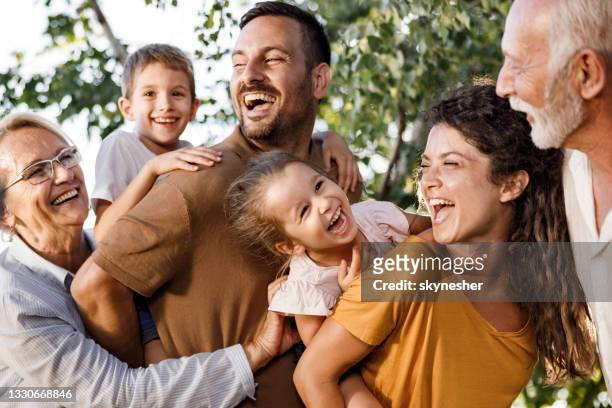 cheerful extended family having fun in nature. - multi generation family stock pictures, royalty-free photos & images