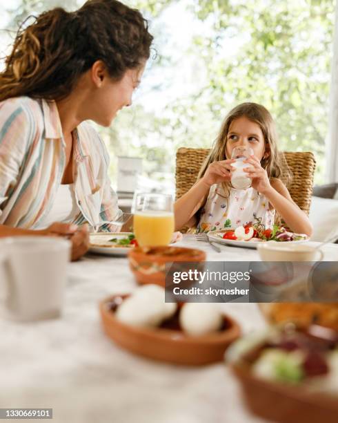 little daughter talking to her dingle mother during breakfast at home. - breakfast table stock pictures, royalty-free photos & images