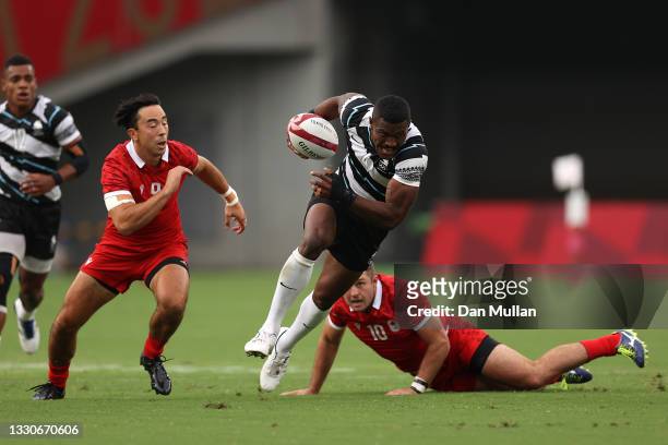 Jiuta Wainiqolo of Team Fiji makes a break to score a try during the Men's Pool B Rugby Sevens match between Fiji and Canada on day three of the...